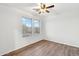 Clean bedroom featuring hardwood floors, a ceiling fan, and natural light from two windows at 2472 W Hawks Eye Ave, Apache Junction, AZ 85120