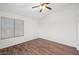 Modest bedroom featuring hardwood floors, a ceiling fan, and a window for natural light at 2472 W Hawks Eye Ave, Apache Junction, AZ 85120