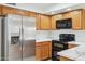 Kitchen featuring stainless steel appliances, oak cabinetry, and modern countertops at 2472 W Hawks Eye Ave, Apache Junction, AZ 85120