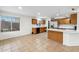 Bright kitchen featuring oak cabinetry, stainless steel appliances, and breakfast bar at 2472 W Hawks Eye Ave, Apache Junction, AZ 85120