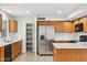 Well-lit kitchen with stainless steel appliances, white countertops and oak cabinets at 2472 W Hawks Eye Ave, Apache Junction, AZ 85120