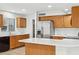 Well-lit kitchen with stainless steel appliances, white countertops and oak cabinets at 2472 W Hawks Eye Ave, Apache Junction, AZ 85120