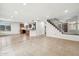 Open-concept living room with tile floors and stairway access to the second floor at 2472 W Hawks Eye Ave, Apache Junction, AZ 85120