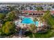 Aerial view of a community with a large pool area surrounded by palm trees and well-maintained landscaping at 2550 E Ellsworth Rd # 791, Mesa, AZ 85209