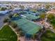 Aerial view of community tennis courts surrounded by mature trees and well-manicured landscaping at 2550 E Ellsworth Rd # 791, Mesa, AZ 85209