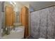 Cozy bathroom featuring wood vanity with storage and shower with decorative shower curtain at 2550 E Ellsworth Rd # 791, Mesa, AZ 85209