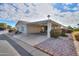 Charming home featuring a covered parking area and vibrant desert landscaping at 2550 E Ellsworth Rd # 791, Mesa, AZ 85209