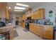 An open-plan kitchen with wood cabinets and countertops, flowing into a dining area at 2550 E Ellsworth Rd # 791, Mesa, AZ 85209