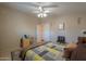 Comfortable main bedroom with tiled floors, a ceiling fan and coordinated neutral decor at 2550 E Ellsworth Rd # 791, Mesa, AZ 85209