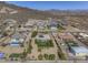 Expansive aerial view of a desert home featuring a pool, solar panels, and low maintenance desert landscaping at 2729 W Dolores Rd, Phoenix, AZ 85086