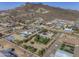 Wide aerial view of the desert home showcasing the pool, landscaping, and mountain views in the background at 2729 W Dolores Rd, Phoenix, AZ 85086