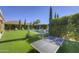 Lush backyard featuring a sparkling pool, manicured lawn, and recreational area at 2729 W Dolores Rd, Phoenix, AZ 85086