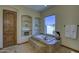 Elegant bathroom with a built-in soaking tub, stylish shelves, and a serene view at 2729 W Dolores Rd, Phoenix, AZ 85086