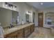 Bathroom featuring dual sinks, granite countertops, tiled floors, and custom cabinets at 2729 W Dolores Rd, Phoenix, AZ 85086