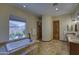 Well-lit bathroom with soaking tub, tiled floors, a custom shower, and dual sinks at 2729 W Dolores Rd, Phoenix, AZ 85086