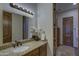 Bathroom with granite counters, undermount sink, decorative lighting, and wood doors at 2729 W Dolores Rd, Phoenix, AZ 85086