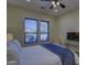 Bright bedroom featuring a ceiling fan and large window at 2729 W Dolores Rd, Phoenix, AZ 85086