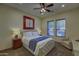 Well-lit bedroom showcasing a ceiling fan and a cozy seating area at 2729 W Dolores Rd, Phoenix, AZ 85086