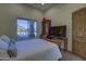 Bedroom featuring a window with views and an antique cabinet with attached television at 2729 W Dolores Rd, Phoenix, AZ 85086