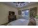 Bright bedroom with a ceiling fan, dresser, and large window offering natural light at 2729 W Dolores Rd, Phoenix, AZ 85086