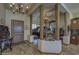 Elegant foyer featuring wood floors, decorative columns, a chandelier, and a grand piano at 2729 W Dolores Rd, Phoenix, AZ 85086