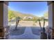 View from the covered front porch looking out at desert landscape and a mountain backdrop at 2729 W Dolores Rd, Phoenix, AZ 85086