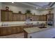 Large kitchen showing expansive granite counters and wooden cabinets, offering ample storage at 2729 W Dolores Rd, Phoenix, AZ 85086