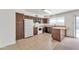 Bright kitchen featuring wooden cabinets, white appliances, and an island with seating at 2815 W Charleston Ave, Phoenix, AZ 85053