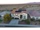 Aerial view of a two-story home in a desert community featuring a tile roof and solar panels at 30402 W Vale Dr, Buckeye, AZ 85396