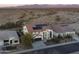 An aerial view showcases the home's desert landscape, front yard, and solar panels on the roof at 30402 W Vale Dr, Buckeye, AZ 85396