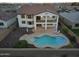 Aerial view of the backyard featuring a large pool with patio seating and a covered balcony at 30402 W Vale Dr, Buckeye, AZ 85396