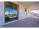 Spacious covered patio/balcony with glass sliding door and outdoor lighting at 30402 W Vale Dr, Buckeye, AZ 85396