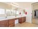 Large bathroom with dual sink vanity, walk-in shower, and decorative mirror at 30402 W Vale Dr, Buckeye, AZ 85396