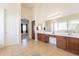 Spacious bathroom with dual sinks, wood cabinets, and tile flooring at 30402 W Vale Dr, Buckeye, AZ 85396