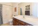 Well-maintained bathroom showcasing a vanity with dark wood cabinets and a shower-tub combination at 30402 W Vale Dr, Buckeye, AZ 85396