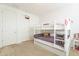 Cozy bedroom with a bunk bed, neutral walls and carpeted floor at 30402 W Vale Dr, Buckeye, AZ 85396