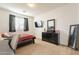 Functional bedroom with TV, black dresser, and a full-length mirror at 30402 W Vale Dr, Buckeye, AZ 85396