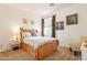 Inviting bedroom with a wooden bed featuring built-in storage drawers and neutral decor at 30402 W Vale Dr, Buckeye, AZ 85396