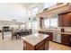 Kitchen area with an island that flows into the dining room with large windows at 30402 W Vale Dr, Buckeye, AZ 85396