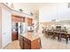 Kitchen with stainless steel appliances that opens up to the dining room and staircase at 30402 W Vale Dr, Buckeye, AZ 85396