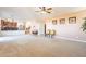 Cozy living room with plush carpeting, leading to a kitchen and staircase at 30402 W Vale Dr, Buckeye, AZ 85396