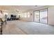 Expansive living room features carpet and sliding glass doors to an outdoor pool area at 30402 W Vale Dr, Buckeye, AZ 85396