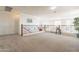 Open loft area with carpet flooring, decorative railing and neutral color palette at 30402 W Vale Dr, Buckeye, AZ 85396