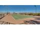 A tennis court with well maintained fences and surrounding trees at 30402 W Vale Dr, Buckeye, AZ 85396