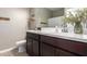 Well-lit bathroom features a vanity with dark cabinets and a large mirror at 30876 W Verde Ln, Buckeye, AZ 85396