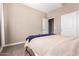 Bedroom with neutral walls and carpet, featuring a neatly made bed at 30876 W Verde Ln, Buckeye, AZ 85396