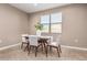 Neutral dining room with a small wood table and four chairs at 30876 W Verde Ln, Buckeye, AZ 85396