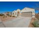 Single-story home with desert landscaping, a two-car garage, and a concrete driveway with sidewalk and street views at 30876 W Verde Ln, Buckeye, AZ 85396