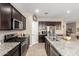 Spacious kitchen featuring stainless steel appliances and a large island with a sink at 30876 W Verde Ln, Buckeye, AZ 85396