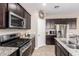 Modern kitchen with stainless steel appliances and granite countertops at 30876 W Verde Ln, Buckeye, AZ 85396